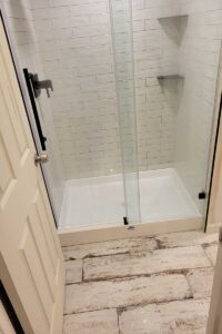 Totally Plumbing - Finished plumbing installation including sink, faucet, toilet, stall shower, and shower trim for full bathroom in Woodbridge, New Jersey – January 2022
