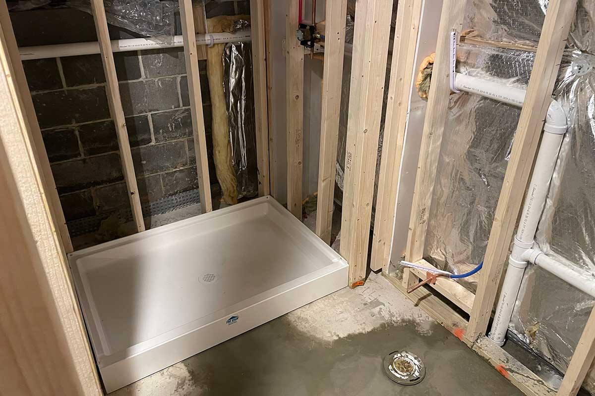 Totally Plumbing - Rough plumbing installation including an ejector tank for a full bathroom with a stall shower in a finished basement - Voorhees, New Jersey – December 2021