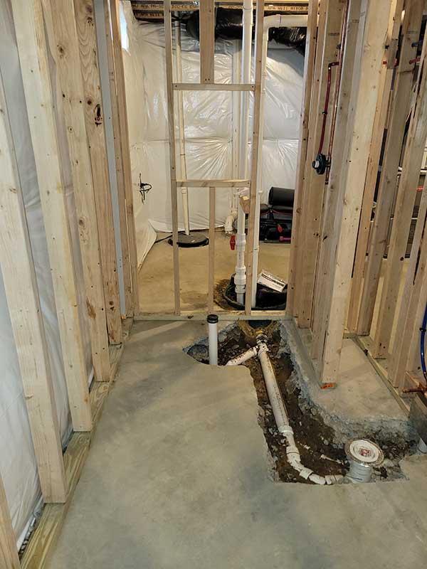 Totally Plumbing - Rough plumbing installation including an ejector tank for a full bathroom with a stall shower in a finished basement - Avondale, Pennsylvania – March 2022