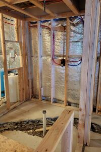 Totally Plumbing - Rough plumbing installation including an ejector tank for a full bathroom with a stall shower and bar sink in a finished basement - Monroe, New Jersey – March 2022