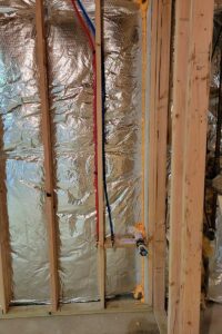 Totally Plumbing - Rough plumbing installation including an ejector tank for a full bathroom with a stall shower and laundry room in a finished basement - East Brunswick, New Jersey – March 2022