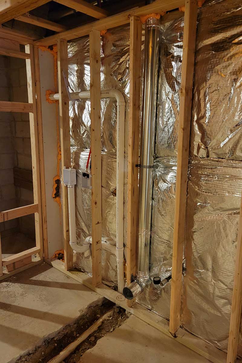 Totally Plumbing - Rough plumbing installation including an ejector tank for a full bathroom with a stall shower and laundry room in a finished basement - East Brunswick, New Jersey – March 2022