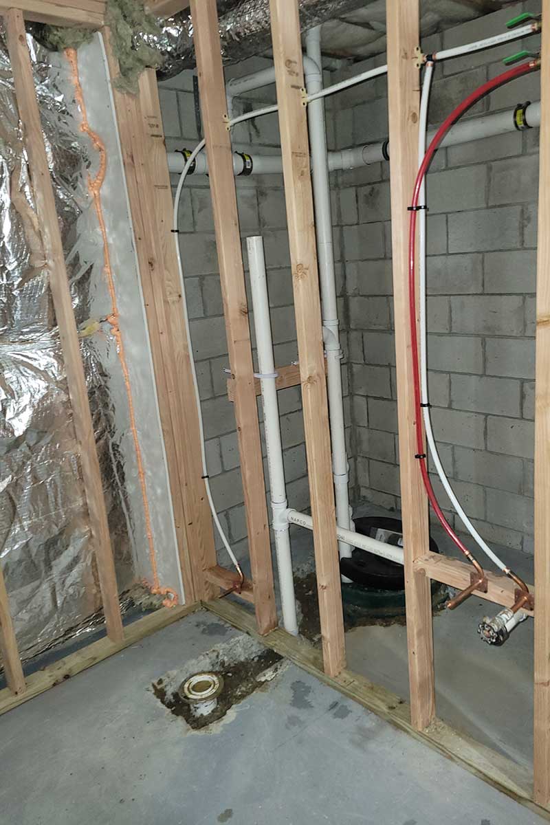 Totally Plumbing - Rough plumbing installation including an ejector tank for a half bathroom in a finished basement - Freehold, New Jersey – March 2022