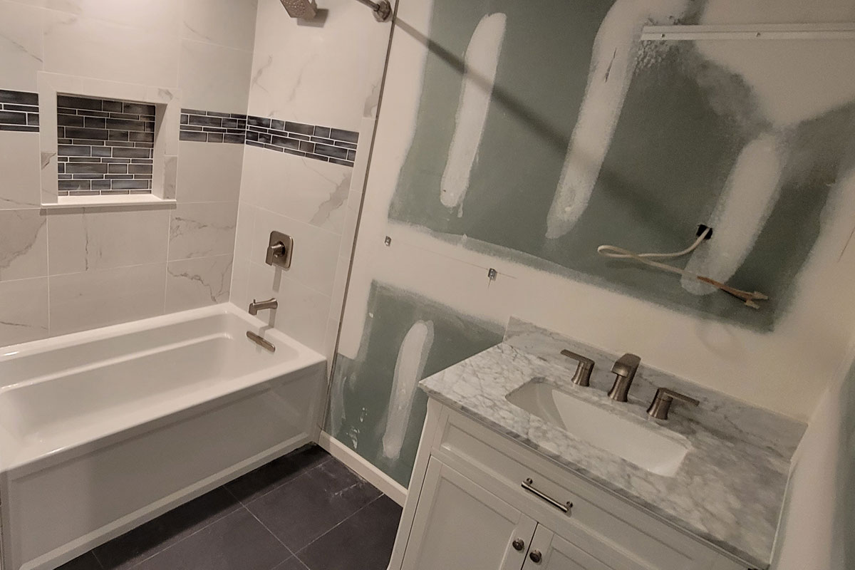 Totally Plumbing - Finished plumbing installation including sink, faucet, toilet, bathtub-shower combination, and shower trim for a full bathroom in a finished basement in Moorestown, New Jersey – July 2022