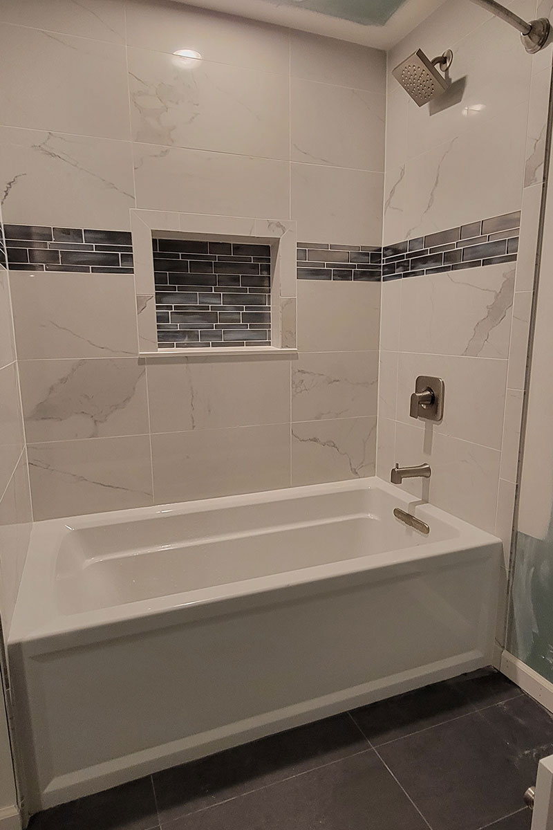 Totally Plumbing - Finished plumbing installation including sink, faucet, toilet, bathtub-shower combination, and shower trim for a full bathroom in a finished basement in Moorestown, New Jersey – July 2022