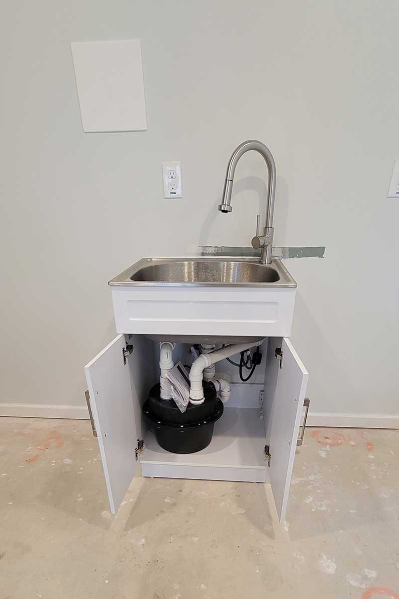 Totally Plumbing - Sink, faucet, and ejector tank installation for a bar in a finished basement - East Brunswick, New Jersey – March 2023