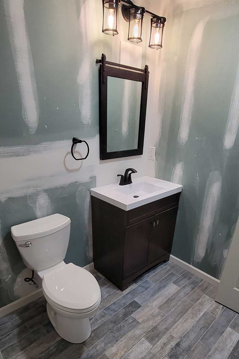 Totally Plumbing - Rough and finished plumbing installation including sink, faucet, toilet, stall shower, and shower trim for a full bathroom in a finished basement in Avenel, New Jersey – March 2023