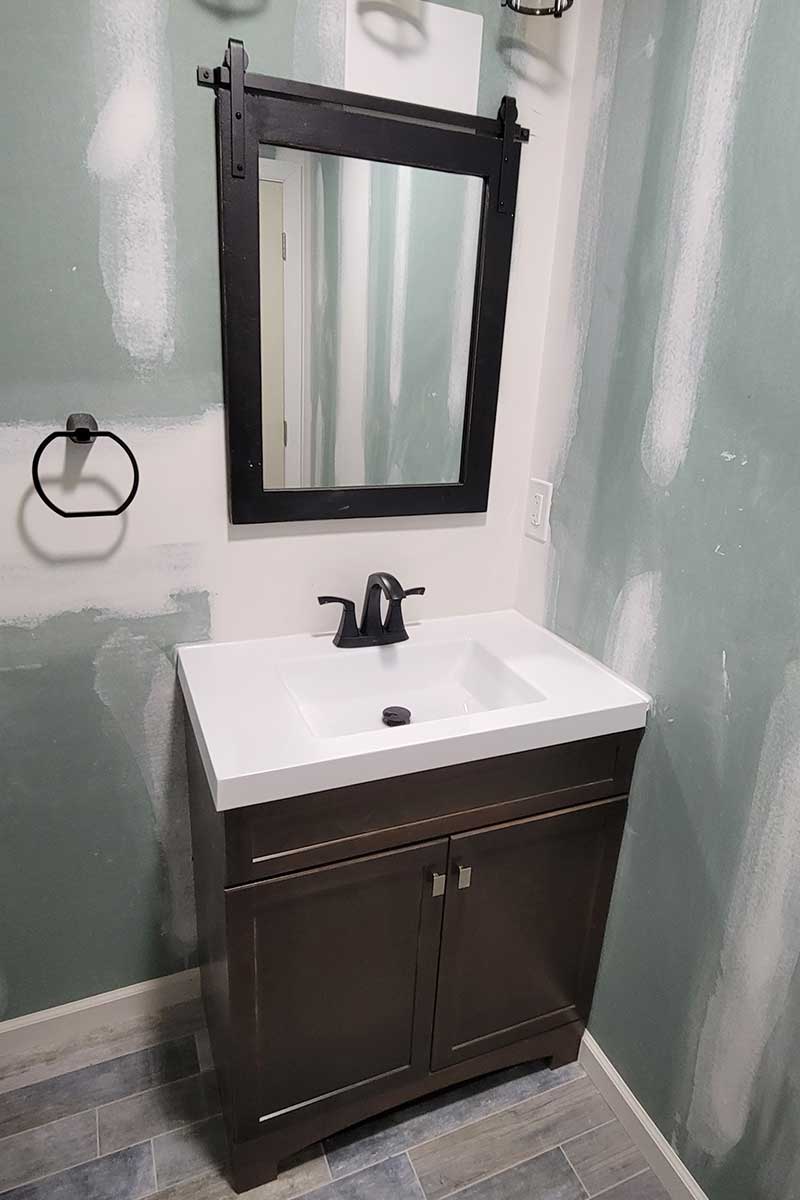 Totally Plumbing - Rough and finished plumbing installation including sink, faucet, toilet, stall shower, and shower trim for a full bathroom in a finished basement in Avenel, New Jersey – March 2023