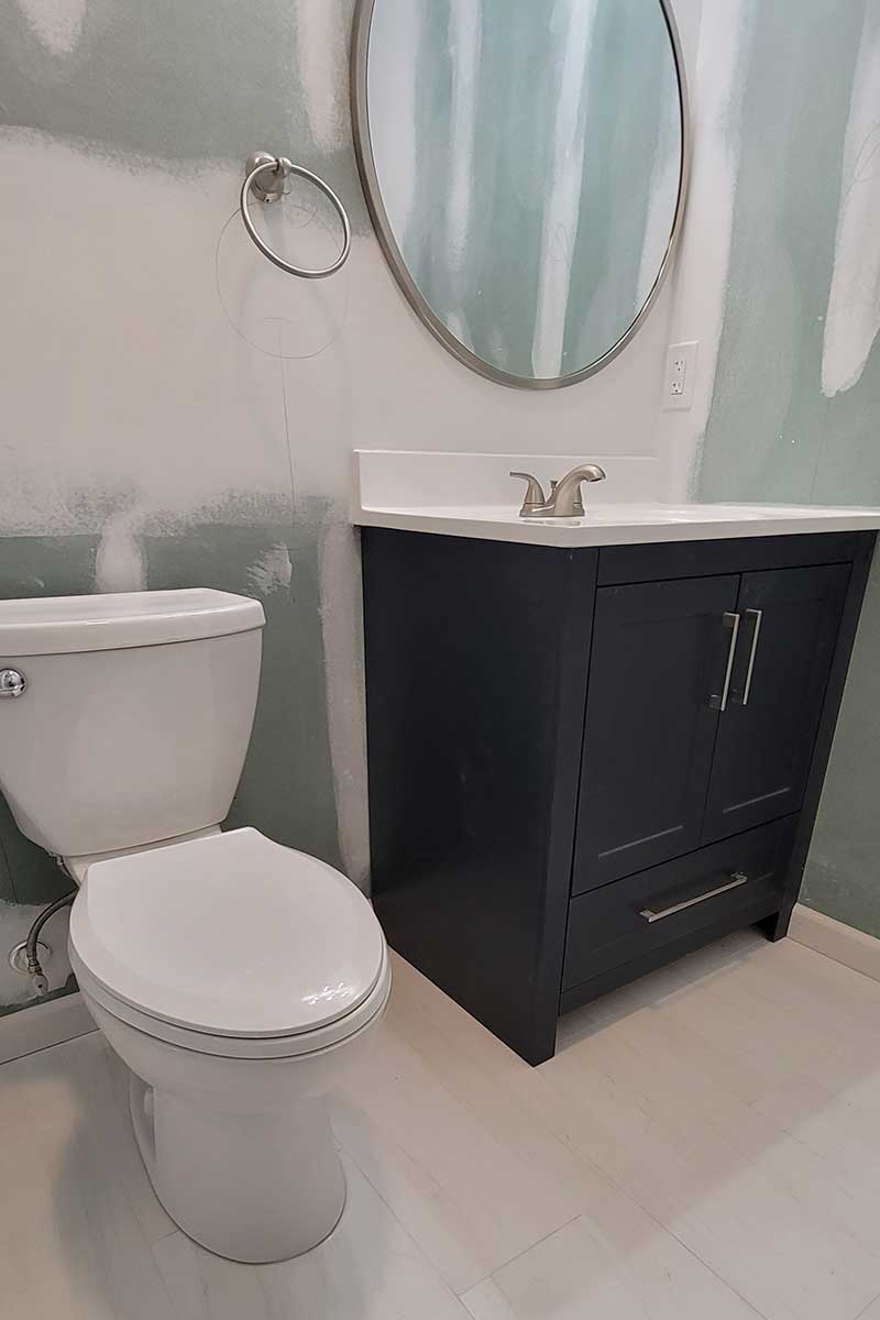 Totally Plumbing - Rough and finished plumbing installation including sink, faucet, toilet, stall shower, and shower trim for a full bathroom in a finished basement in Toms River, New Jersey – March 2023