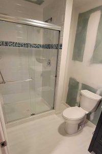 Totally Plumbing - Rough and finished plumbing installation including sink, faucet, toilet, stall shower, and shower trim for a full bathroom in a finished basement in Toms River, New Jersey – March 2023