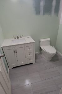 Totally Plumbing - Rough and finished plumbing installation including sink, faucet, and toilet for a half bathroom in a finished basement in Warren, New Jersey – June 2023