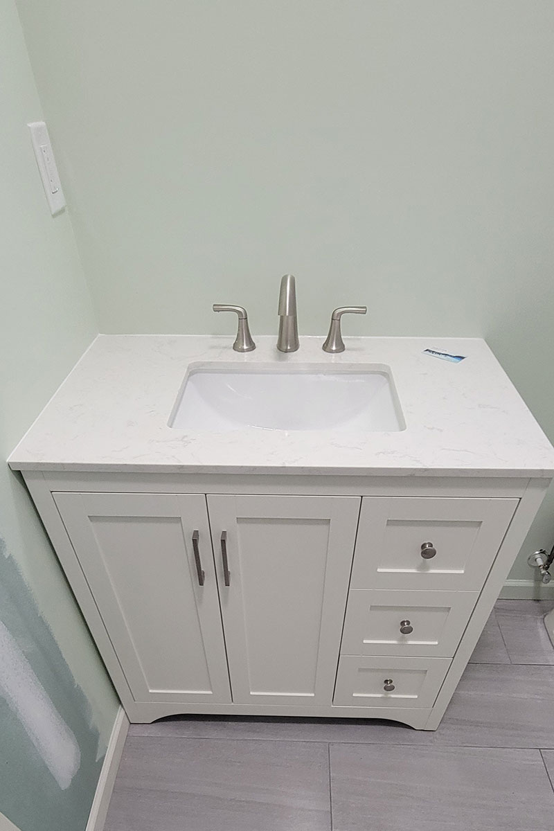 Totally Plumbing - Rough and finished plumbing installation including sink, faucet, and toilet for a half bathroom in a finished basement in Warren, New Jersey – June 2023