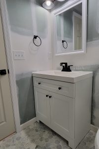 Totally Plumbing - Finished plumbing installation including vanity, sink, faucet, toilet, stall shower, and shower trim for a full bathroom and vanity, sink, and faucet for a wet bar in a finished basement in Neptune, New Jersey – September 2023